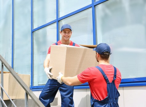 Moving boxes and furniture with a removals van in West Hampstead