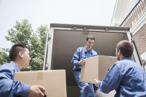 Helper loading furniture for a West Hampstead move