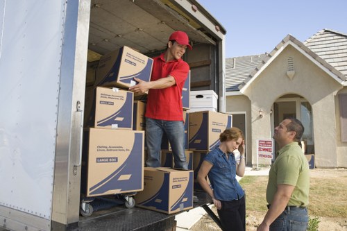 Professional removals team packing flat belongings in Westhampstead