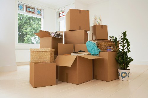 Mover carrying furniture for a flat move in West Hampstead