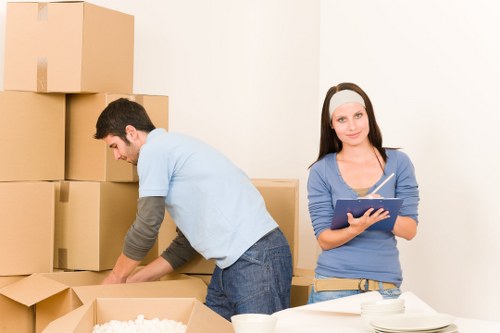 Household boxes and furniture being transported by a moving van in West Hampstead